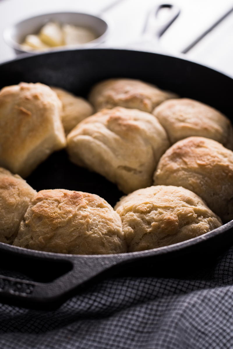 Cast iron skillet with biscuits featuring food, baked, and baked goods