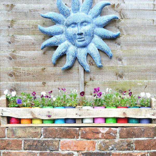 Colorful Tin Can Planters in Pallet Holder