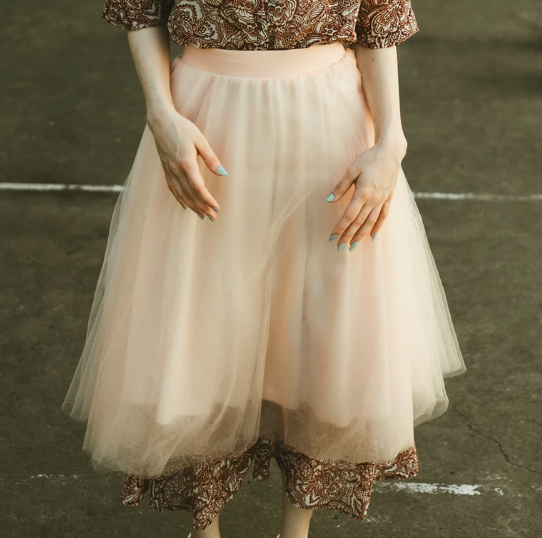 Images shows a close-up of a person wearing a tulle skirt.