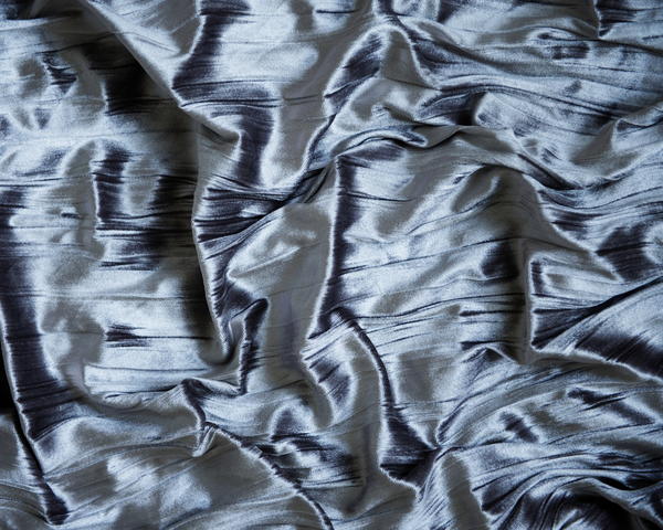 Image shows a gray and shiny and slippery fabric.