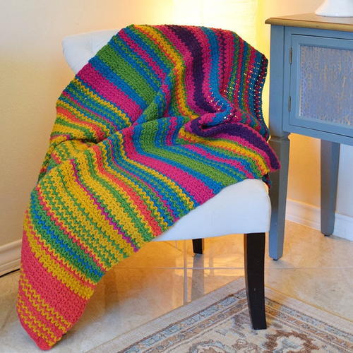 Image shows the Must-Make Crochet Temperature Afghan laid over a chair.