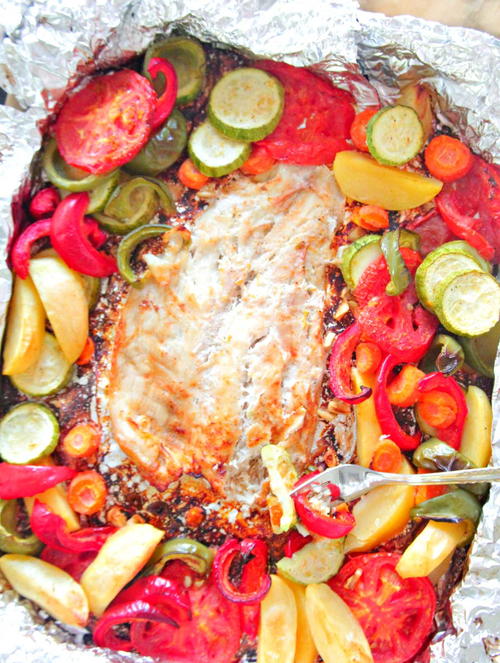 Baked fish in foil with vegetables
