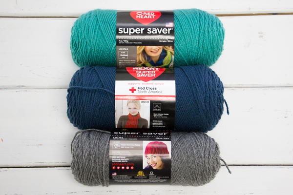 Image shows three skeins of yarn in teal, blue, and gray.