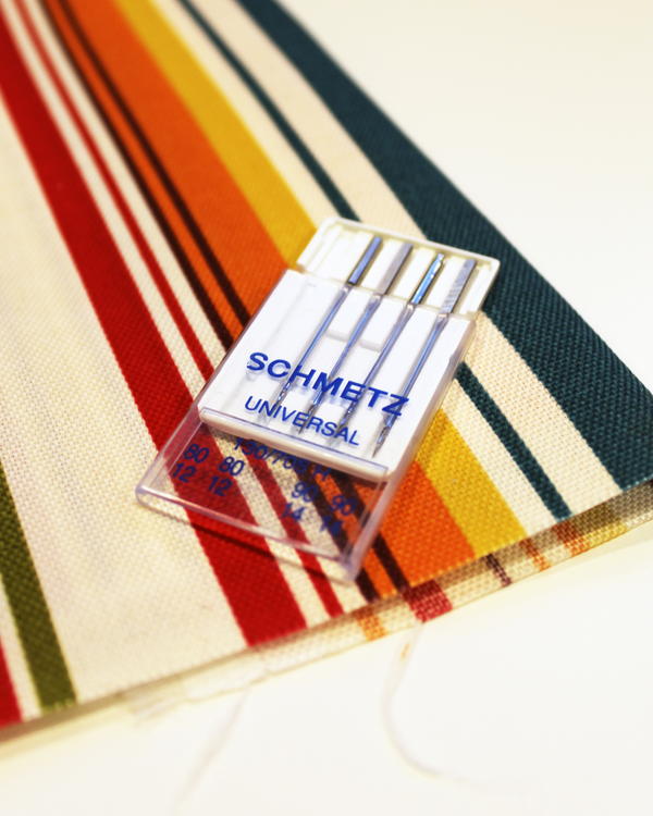 Example of canvas and sewing machine needles.