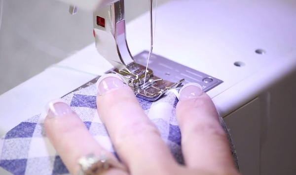 Image shows the floss method of gathering fabric being sewn on a sewing machine.