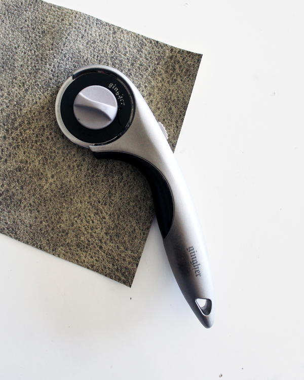 Image shows a rotary cutter sitting on a piece of vinyl.
