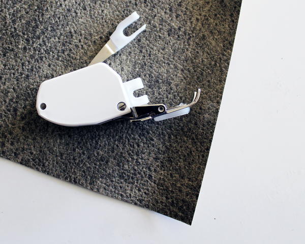 Example of a sewing machine walking foot attachment.