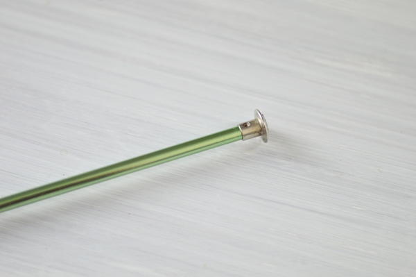 Image shows the capped end of a 14-inch Tunisian crochet hook.