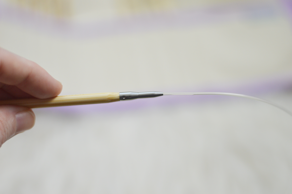Image shows a close up of the shorter Tunisian hook with an extension cord.