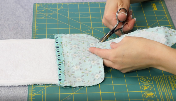 Image shows the fabric pattern pieces (now sewn together) being clipped at the curves.