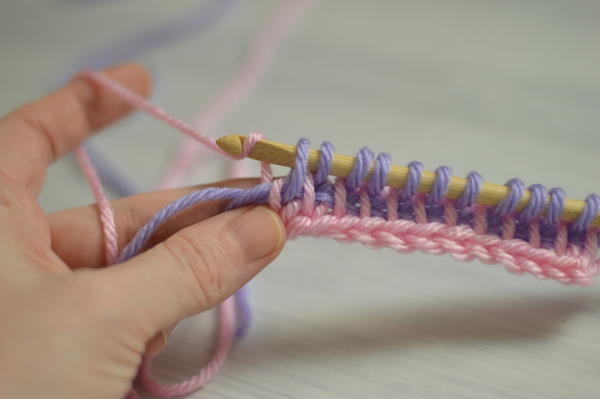 Image shows the sixth step in changing color at the beginning of the return pass in Tunisian crochet.