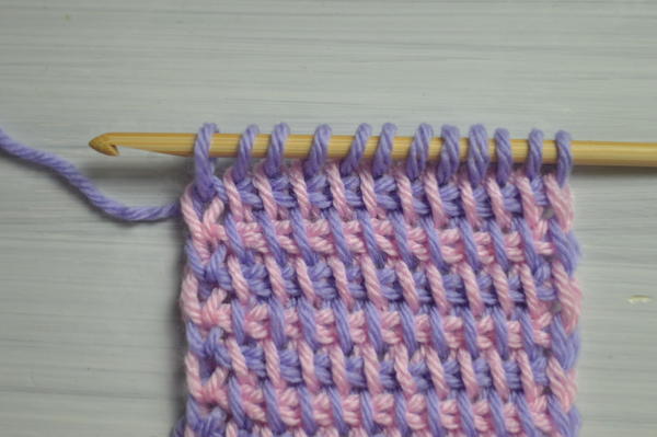 Image shows a swatch after finishing the steps in changing color at the beginning of the return pass in Tunisian crochet.