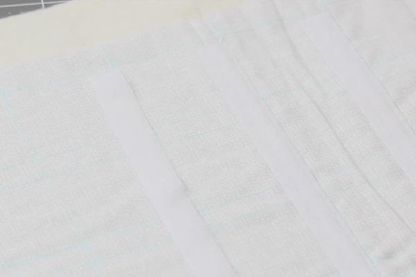 Image shows a piece of light fabric with blue lines and pieces of Velcro aligned to fit the lines.