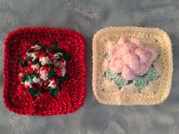 Image shows two granny squares with 3D flowers in the center. They are side by side.