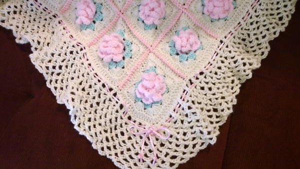 Image shows a close-up of a granny square blanket.