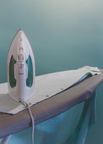 Ironing board with fabric and an iron