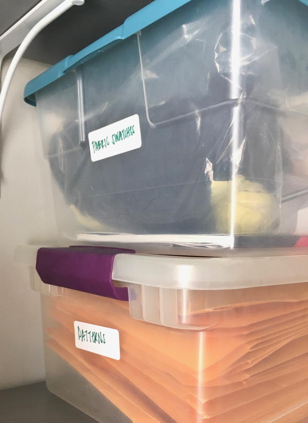 Image shows clear tubs with sewing items inside and labels on the outsides.