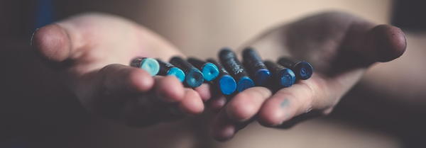 Hands holding blue pastels