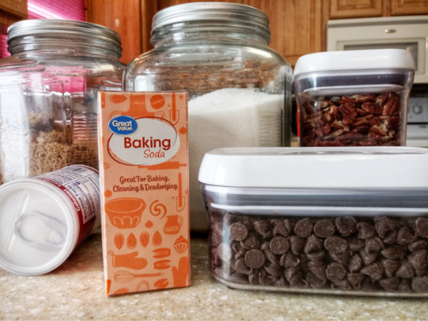 Baking essentials to stock in a pantry including baking soda, sugar, and chocolate chips