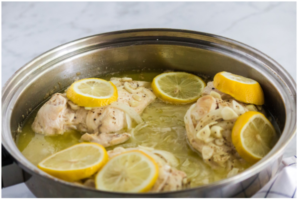 Garlic and lemon chicken in a stainless steel pan