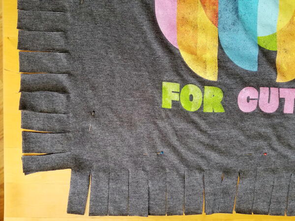 Image shows a close-up of the shirt with 1" strips cut.