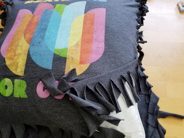 Image shows a close-up of the shirt with 1" strips tied and the pillow form inside with one side open.