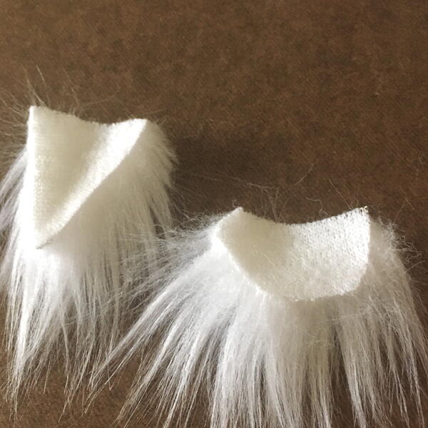 Image shows the cut white faux fur fabric beard pieces for the DIY Gnome Ornament.