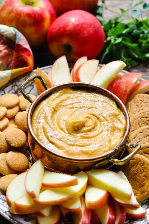 dish-of-caramel-apple-dip-being-stirred-with-a-spoon