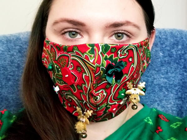 Image shows a woman wearing a DIY Ugly Face Mask for Christmas.