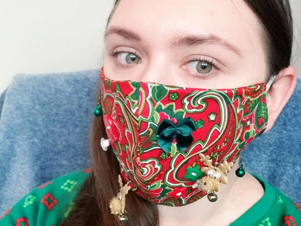 Image shows a woman wearing a DIY Ugly Face Mask for Christmas.