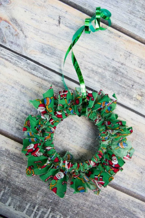 Mason Jar Lid Christmas Wreath Ornament Craft | AllFreeHolidayCrafts.com