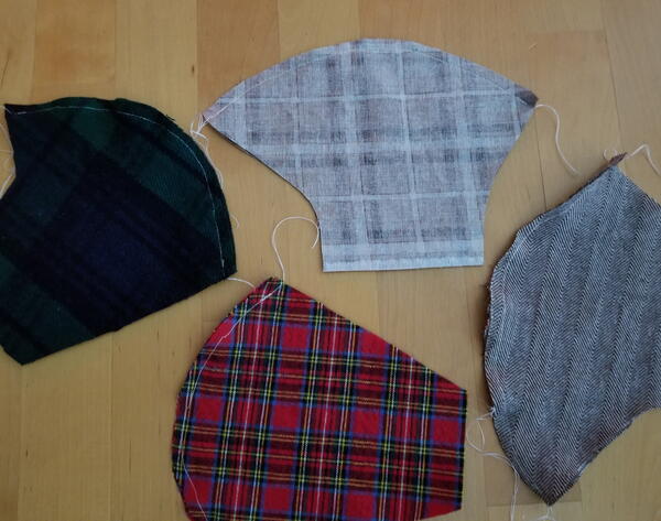 Image shows four sewn fabric mask pairs.