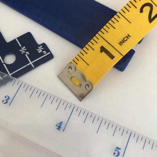Image shows sewing rulers and measuring tape.