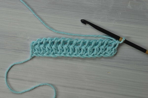 Image shows the current progress for the Tunisian double crochet piece.