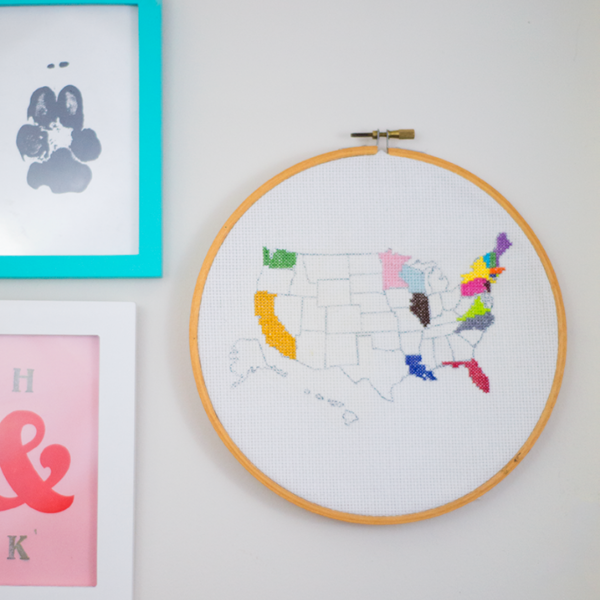 Example of cross-stitch embroidery: a partially-filled-in map of the U.S. in a wood embroidery hoop.