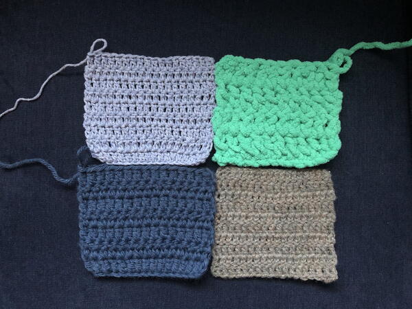 Image shows four rectangle swatches, all of different weights, put together and ready to be sewn into one piece.