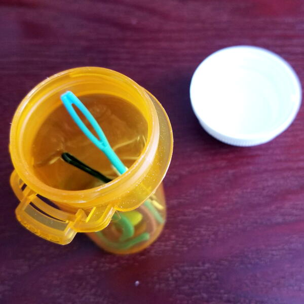 Pill bottle holder for small sewing notions