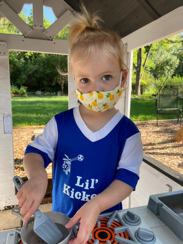 Image shows a small girl wearing the DIY mask.