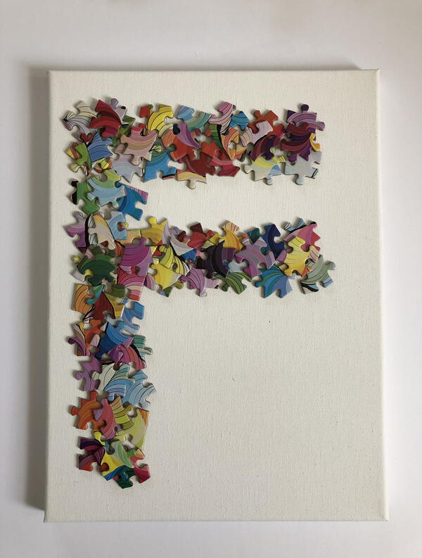 The completed puzzle piece monogram on canvas