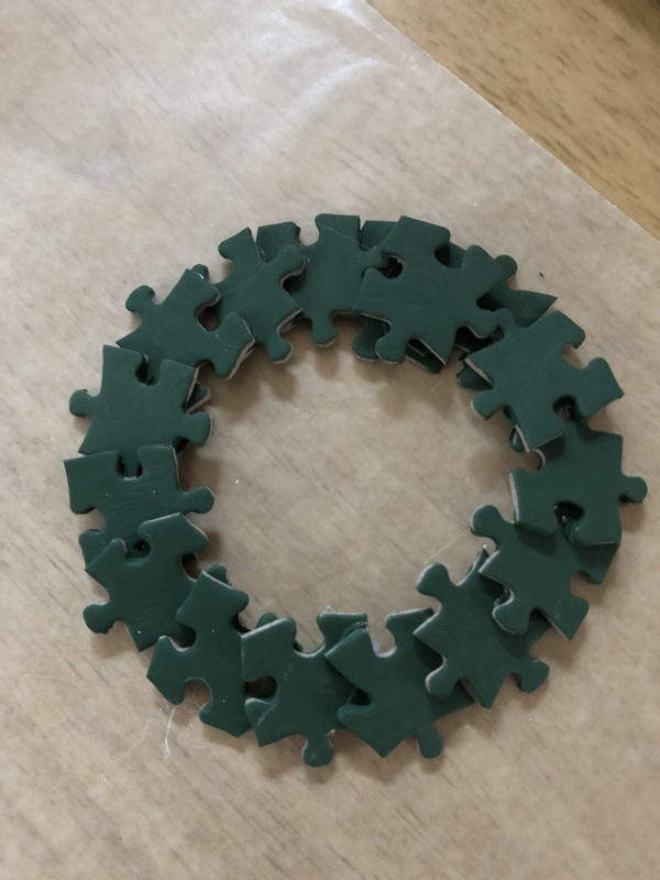 Glue the puzzle pieces together to form your wreath ornament