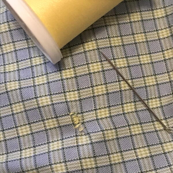 Hand Sewing Clothing Repair: Torn shirt repaired by hand