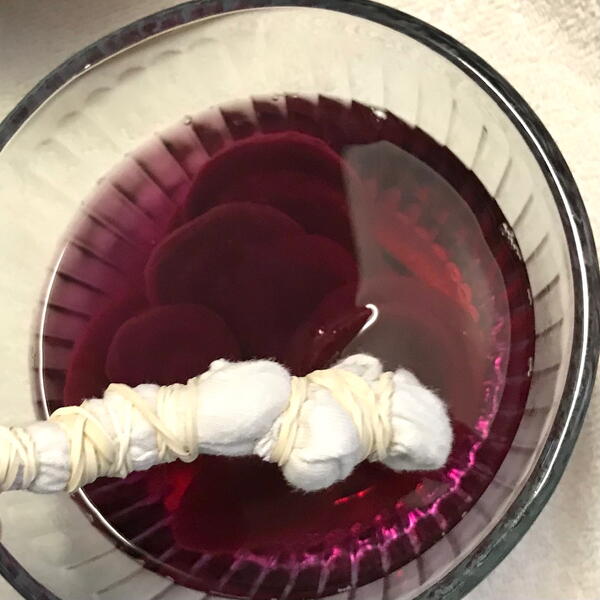 Submerge the fabric in the fresh red beet dye.
