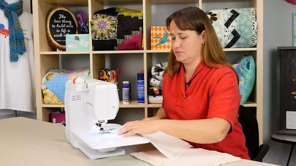 A woman sitting and sewing