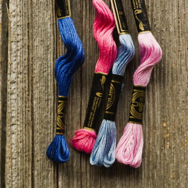 Image shows four brightly colored embroidery flosses