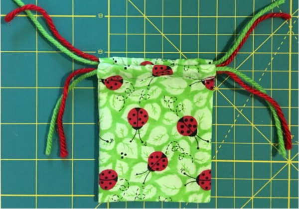 Image shows the finished DIY mini drawstring bag.
