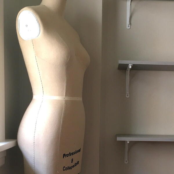 Image shows a dress form, also known as a mannequin or tailors dummy.
