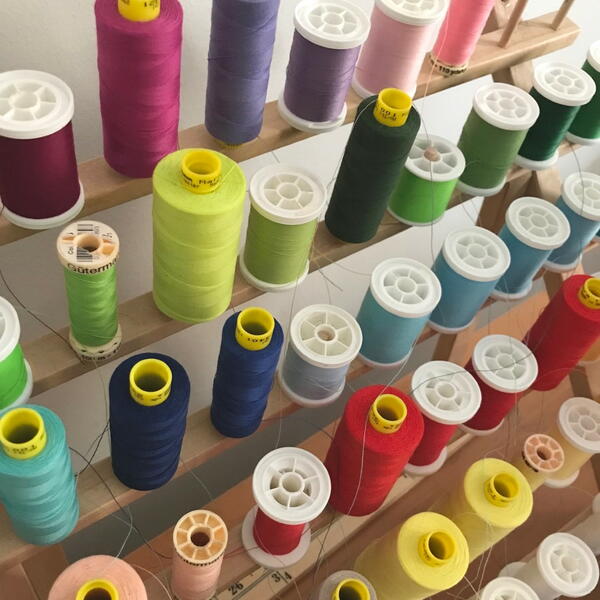Image shows a thread holder full of different shades of thread.