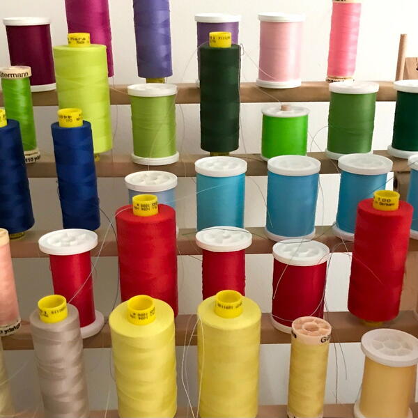 Image shows a thread holder full of different shades of thread.