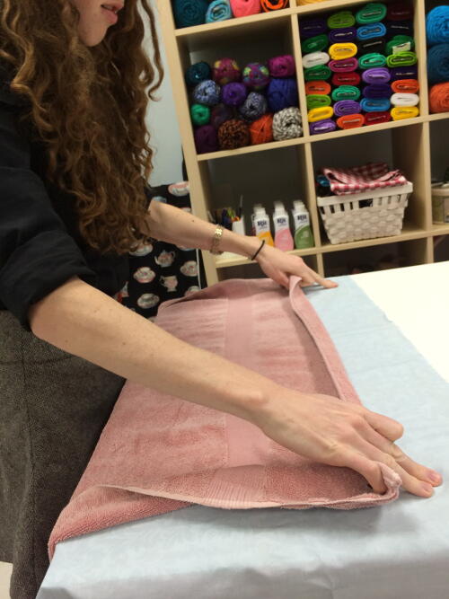 How to Iron Without an Iron: Damp Towel Laid on Fabric