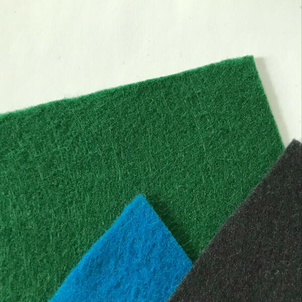 Flat felt sheets in green, blue, and black.